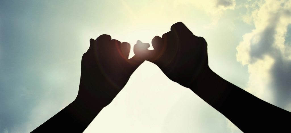 A picture of a pinky promise in a wedding ceremony