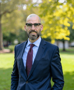 DudeistJon as a wedding officiant dressed in navy blue suit and red tie at Cincinnati Park for elopement ceremony